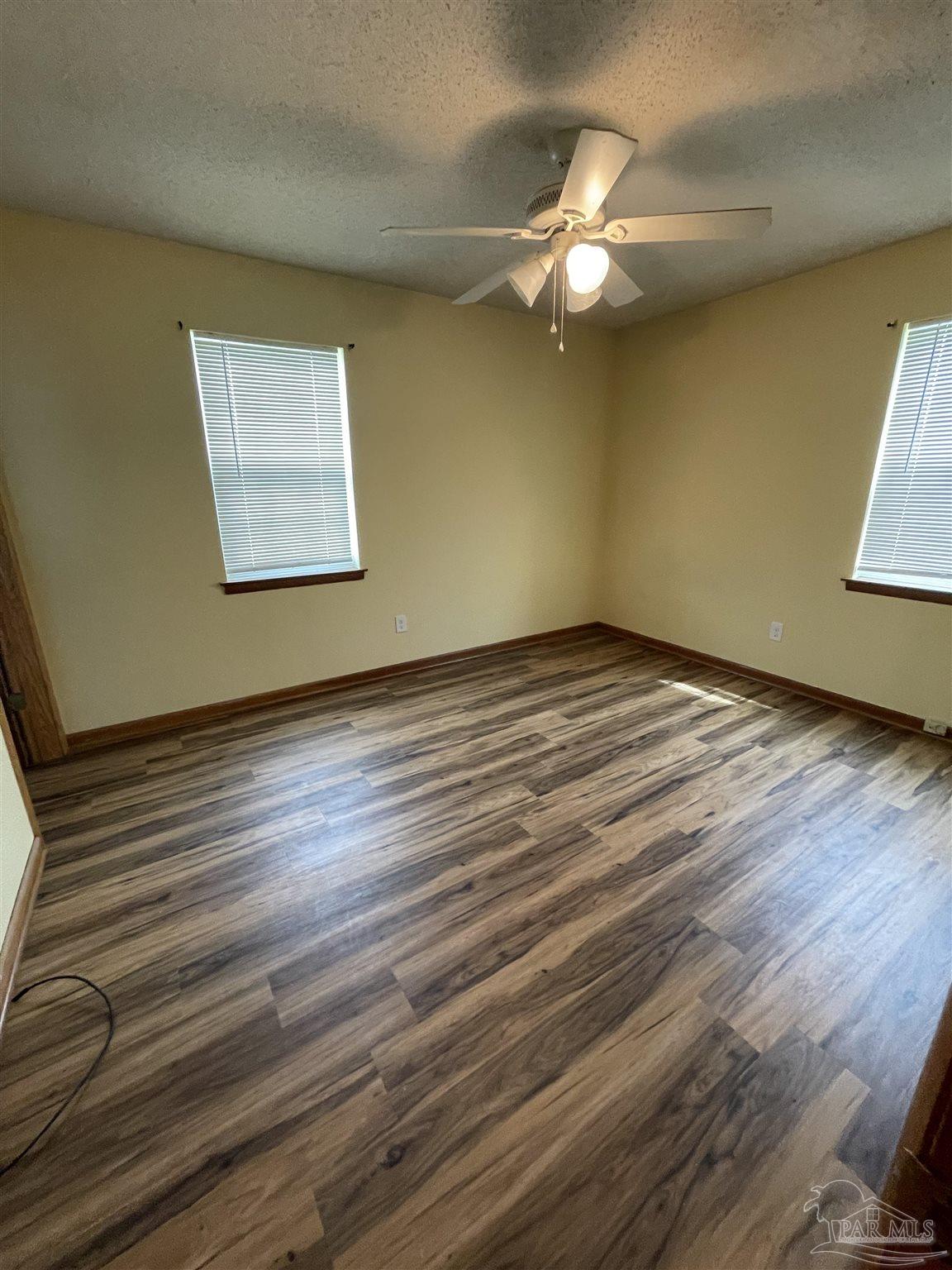 9550 Highway 89 Milton, FL 32570 - Photo 16 of 18 a view of an empty room with wooden floor and a window
