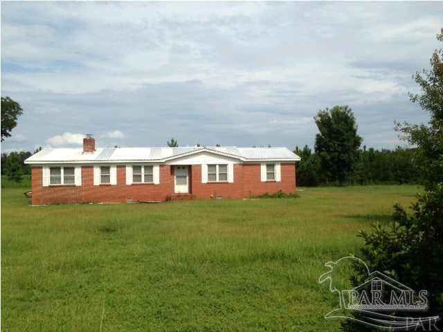 9550 Highway 89 Milton, FL 32570 - Photo 2 of 18 a front view of a house with a garden