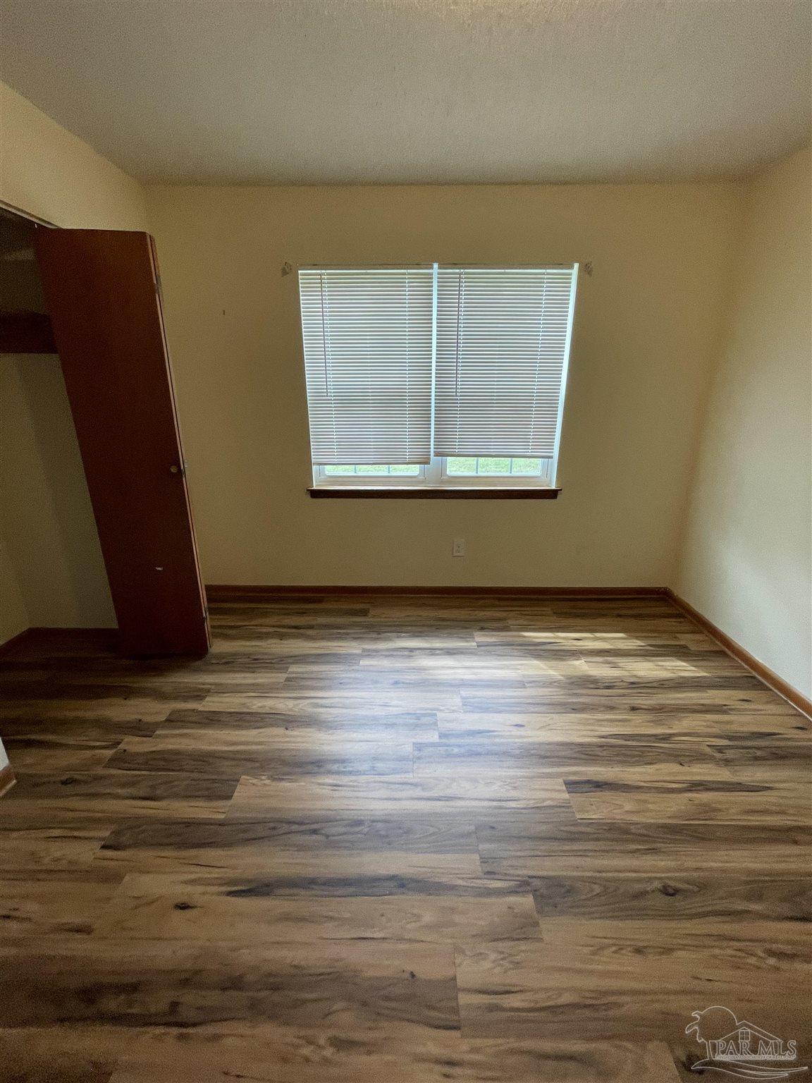 9550 Highway 89 Milton, FL 32570 - Photo 8 of 18 a view of empty room with window and wooden floor