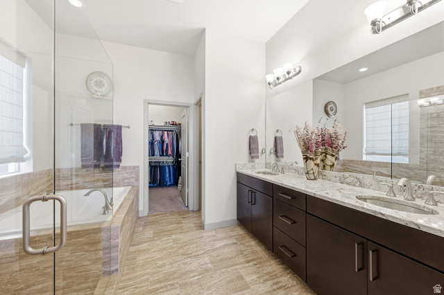 987 East Deer Arch Lane Draper, UT 84020 - Photo 25 of 46 Primary ensuite bathroom featuring double vanity, a spacious closet, and separate garden tub and shower