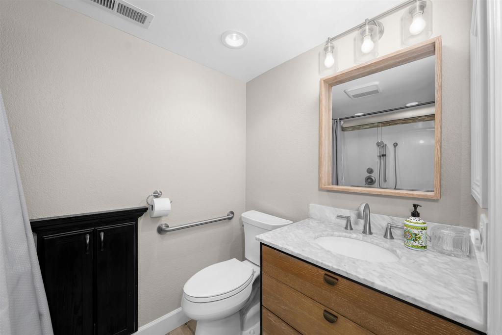 4363 Country Trails Lane Bonita, CA 91902 - Photo 12 of 27 a bathroom with a granite countertop sink toilet and mirror
