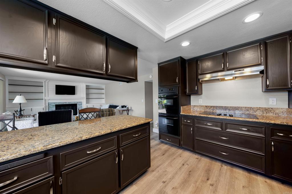 4363 Country Trails Lane Bonita, CA 91902 - Photo 8 of 27 a kitchen with stainless steel appliances granite countertop wooden cabinets and a refrigerator