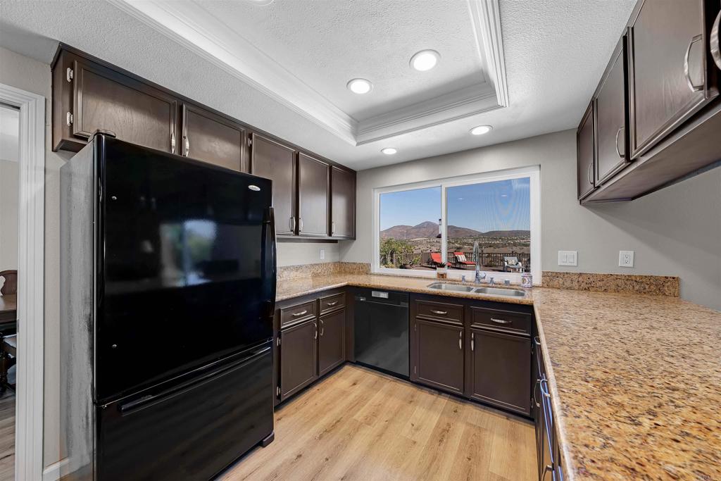 4363 Country Trails Lane Bonita, CA 91902 - Photo 9 of 27 a kitchen with stainless steel appliances granite countertop a refrigerator and a sink