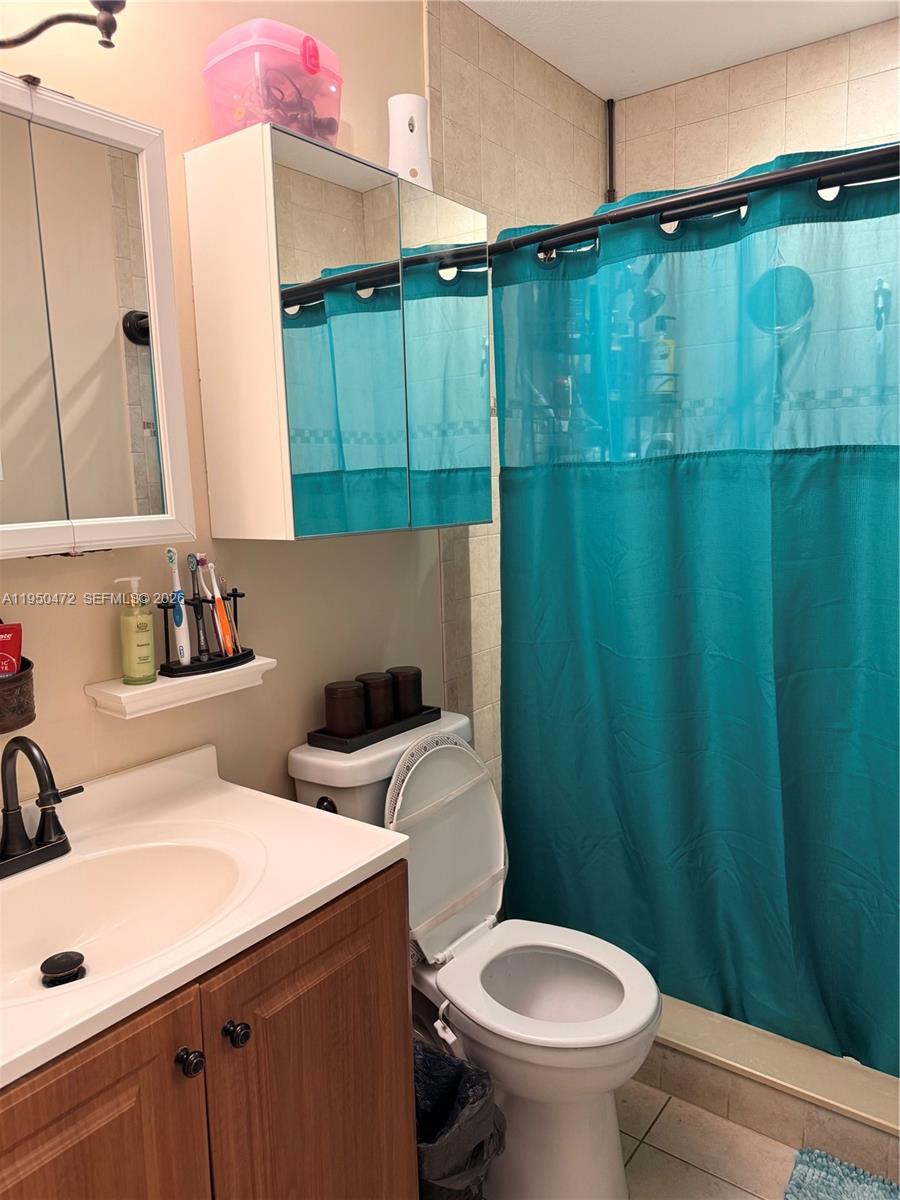 309 Northwest 15th Street Homestead, FL 33030 - Photo 11 of 19 a bathroom with a sink a toilet and a mirror