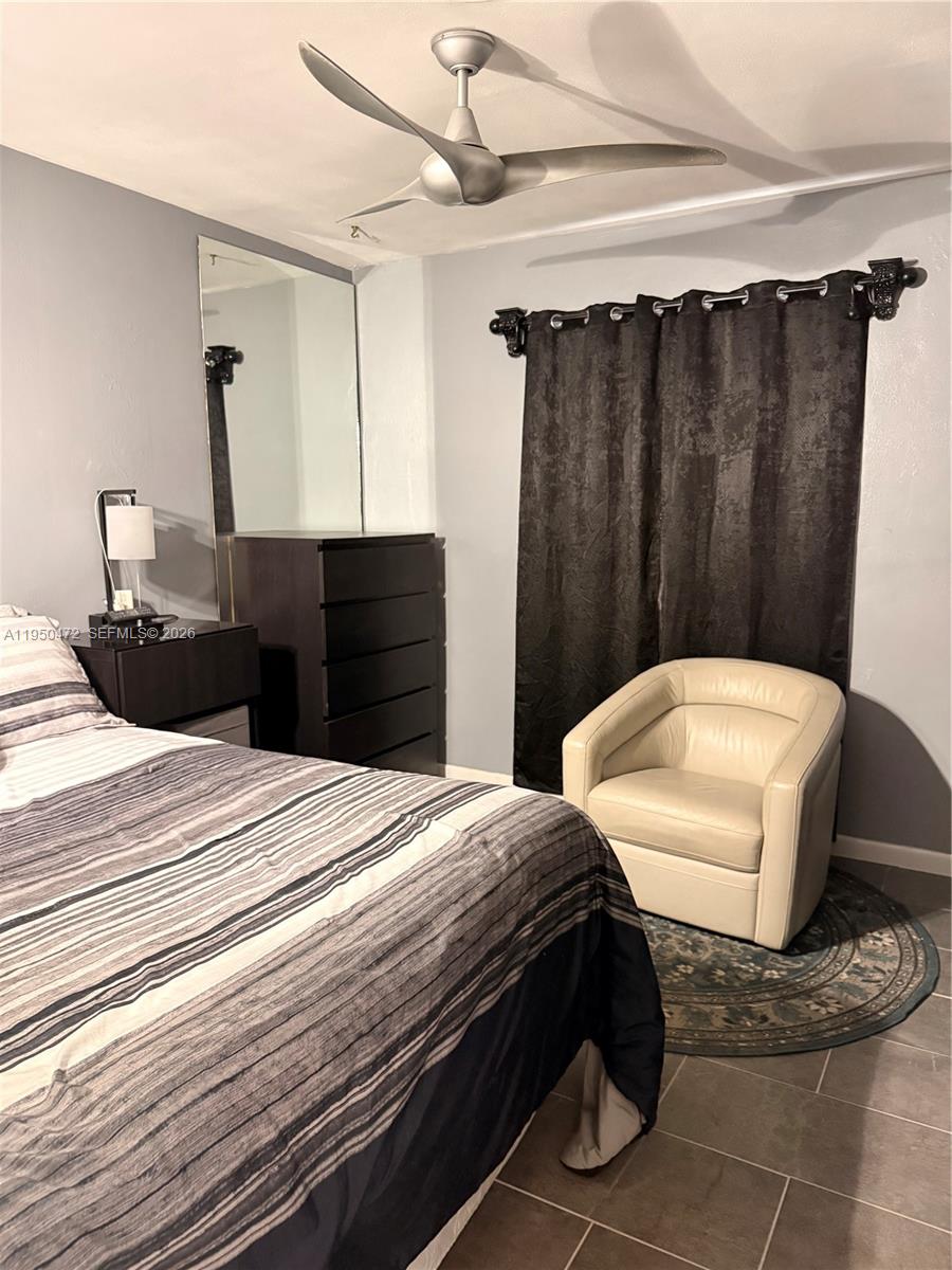 309 Northwest 15th Street Homestead, FL 33030 - Photo 12 of 19 a bedroom with a bed a mirror and a shower