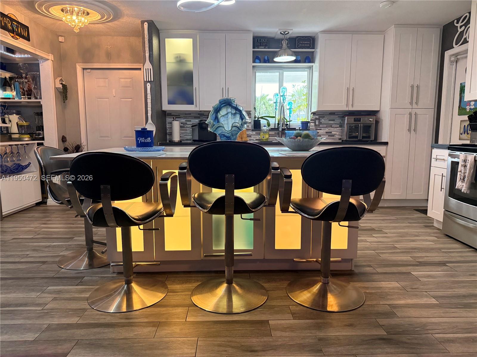 309 Northwest 15th Street Homestead, FL 33030 - Photo 4 of 19 a kitchen with sink refrigerator dining table and chairs