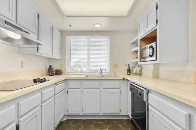 a kitchen with a sink and cabinets
