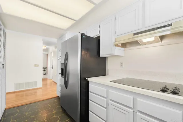 a kitchen with stainless steel appliances a refrigerator and a sink