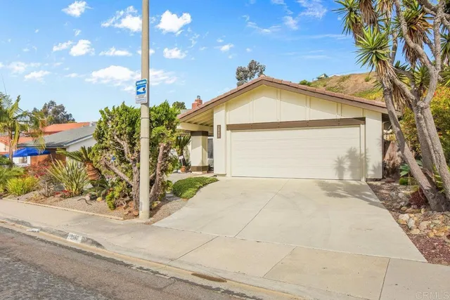 a view of a house with a yard and garage