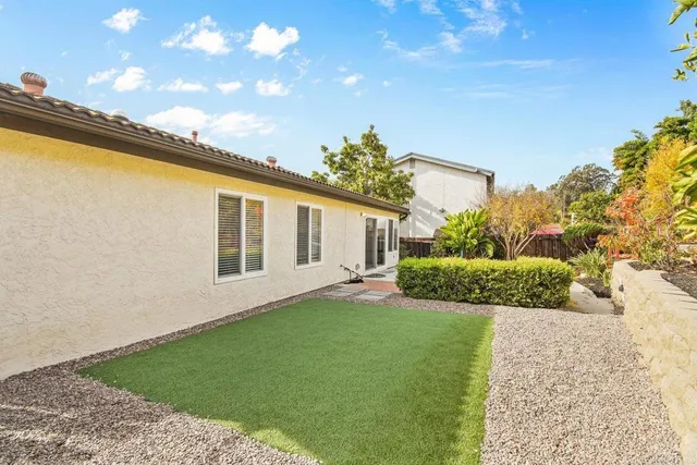 a view of a backyard with plants and a garden