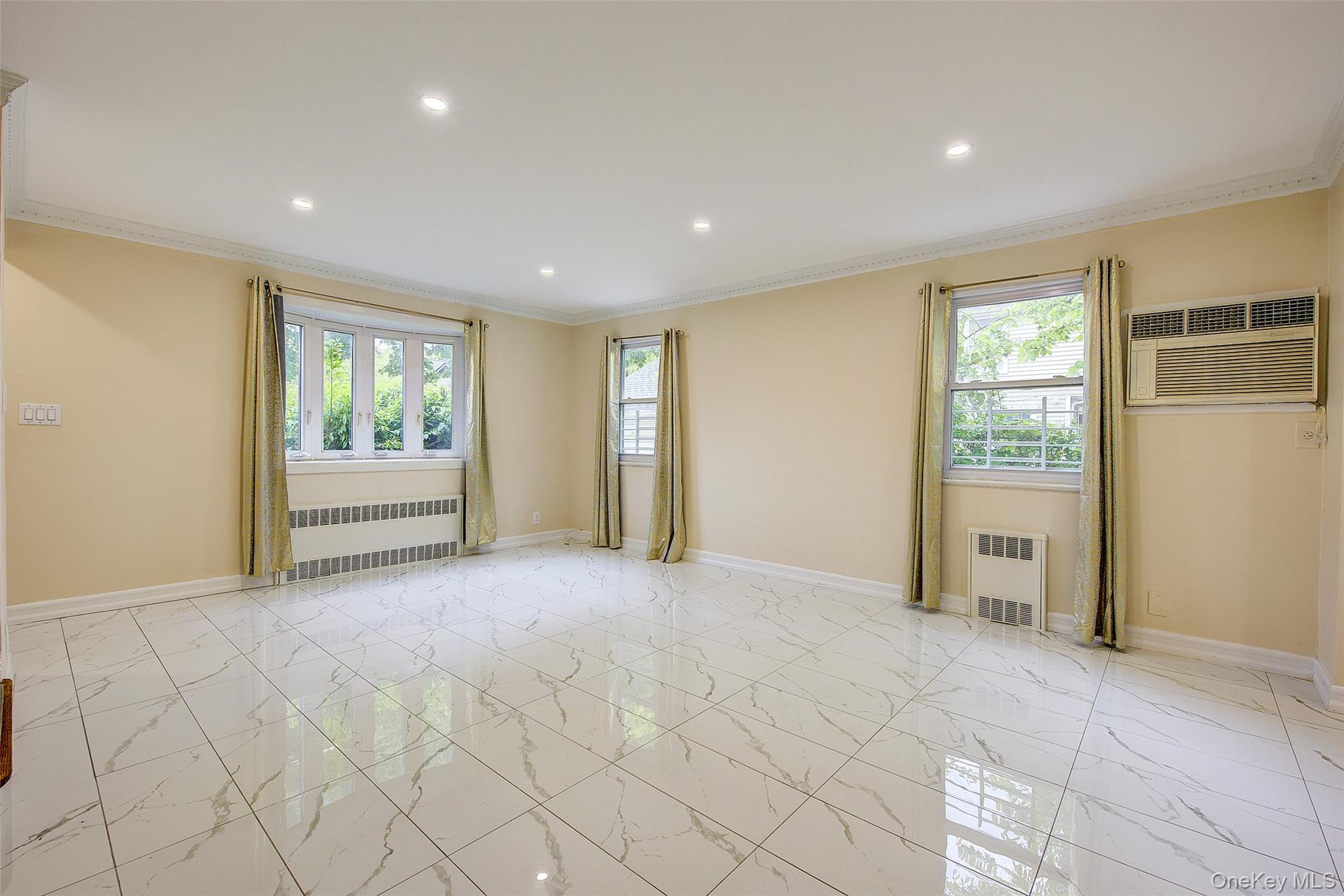 164-38 76th Road Queens, NY 11366 - Photo 2 of 44 a view of an empty room with a window