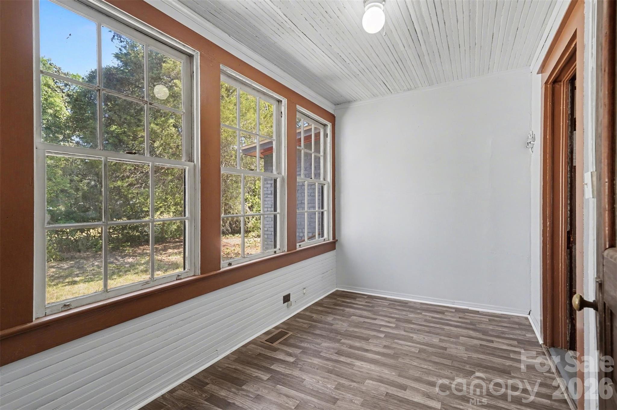 215 Theodore R Carr Avenue Morven, NC 28119 - Photo 11 of 28 a view of an empty room with wooden floor and a window