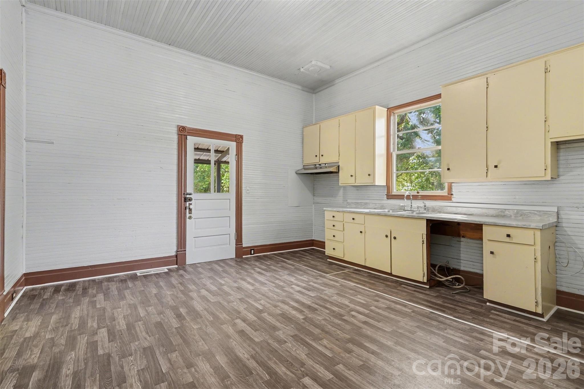 215 Theodore R Carr Avenue Morven, NC 28119 - Photo 12 of 28 a view of a kitchen with wooden floor and a window