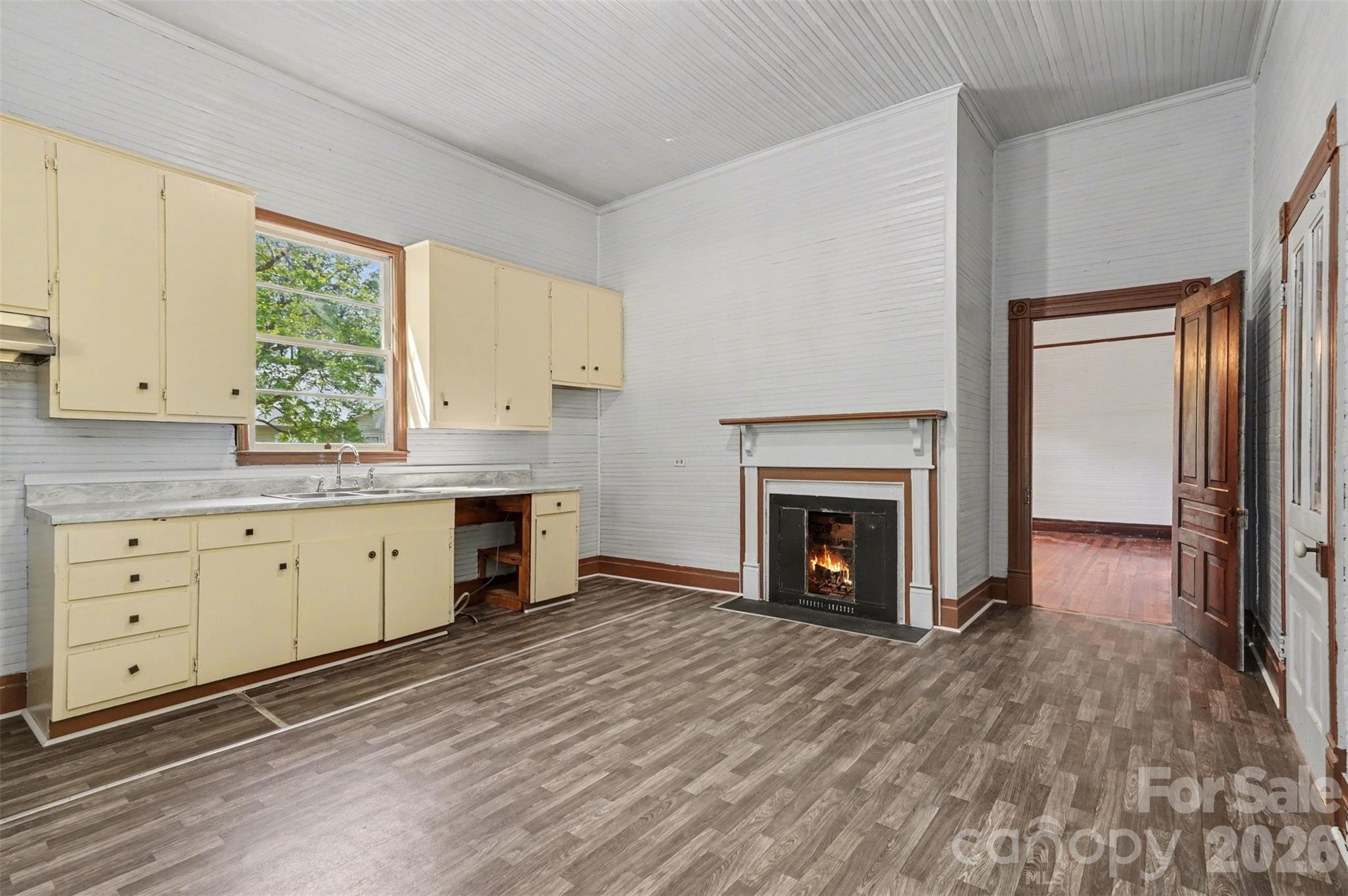 215 Theodore R Carr Avenue Morven, NC 28119 - Photo 13 of 28 a view of an empty room with a fireplace and a window