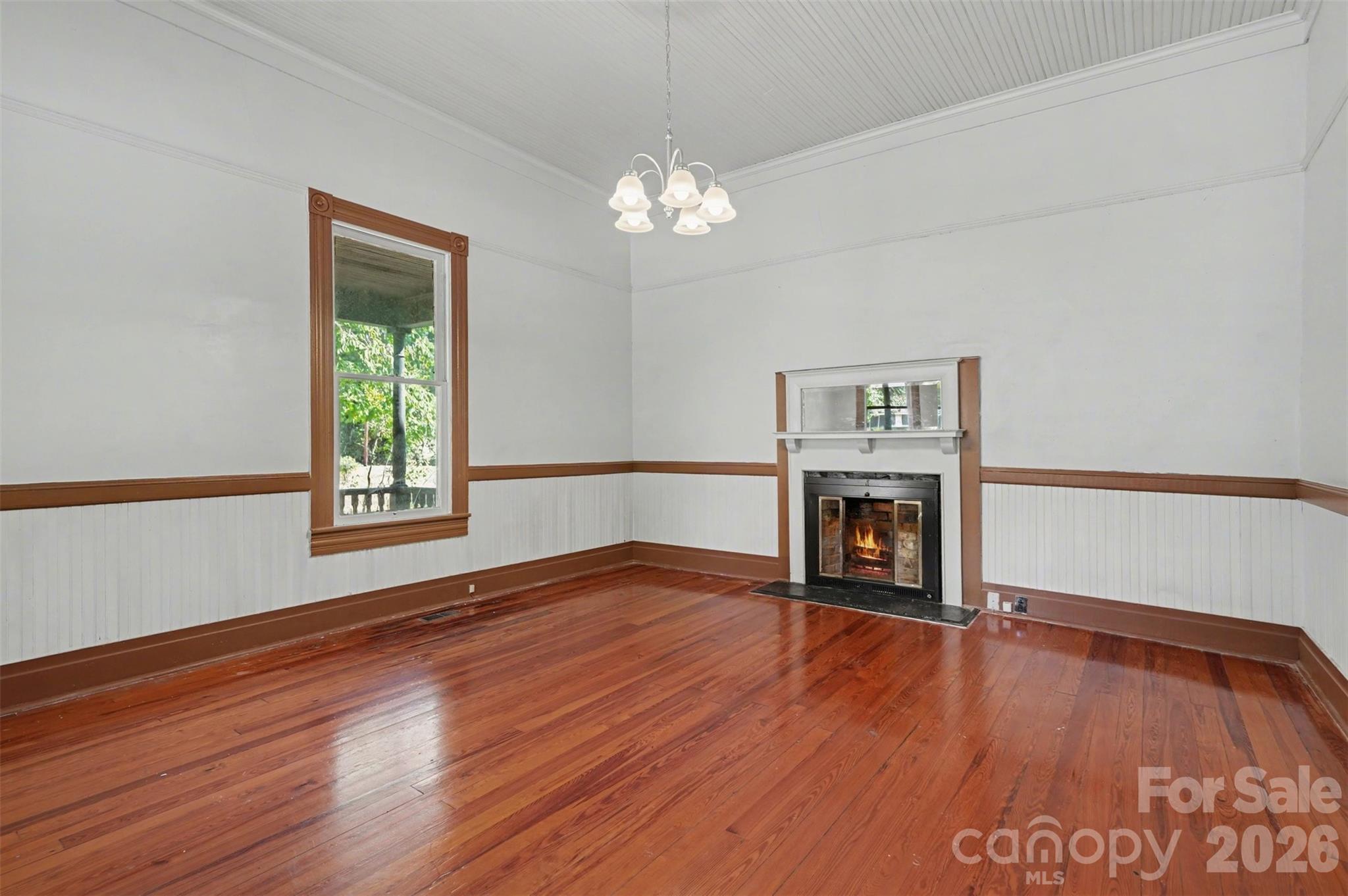 215 Theodore R Carr Avenue Morven, NC 28119 - Photo 15 of 28 a view of an empty room with window and wooden floor