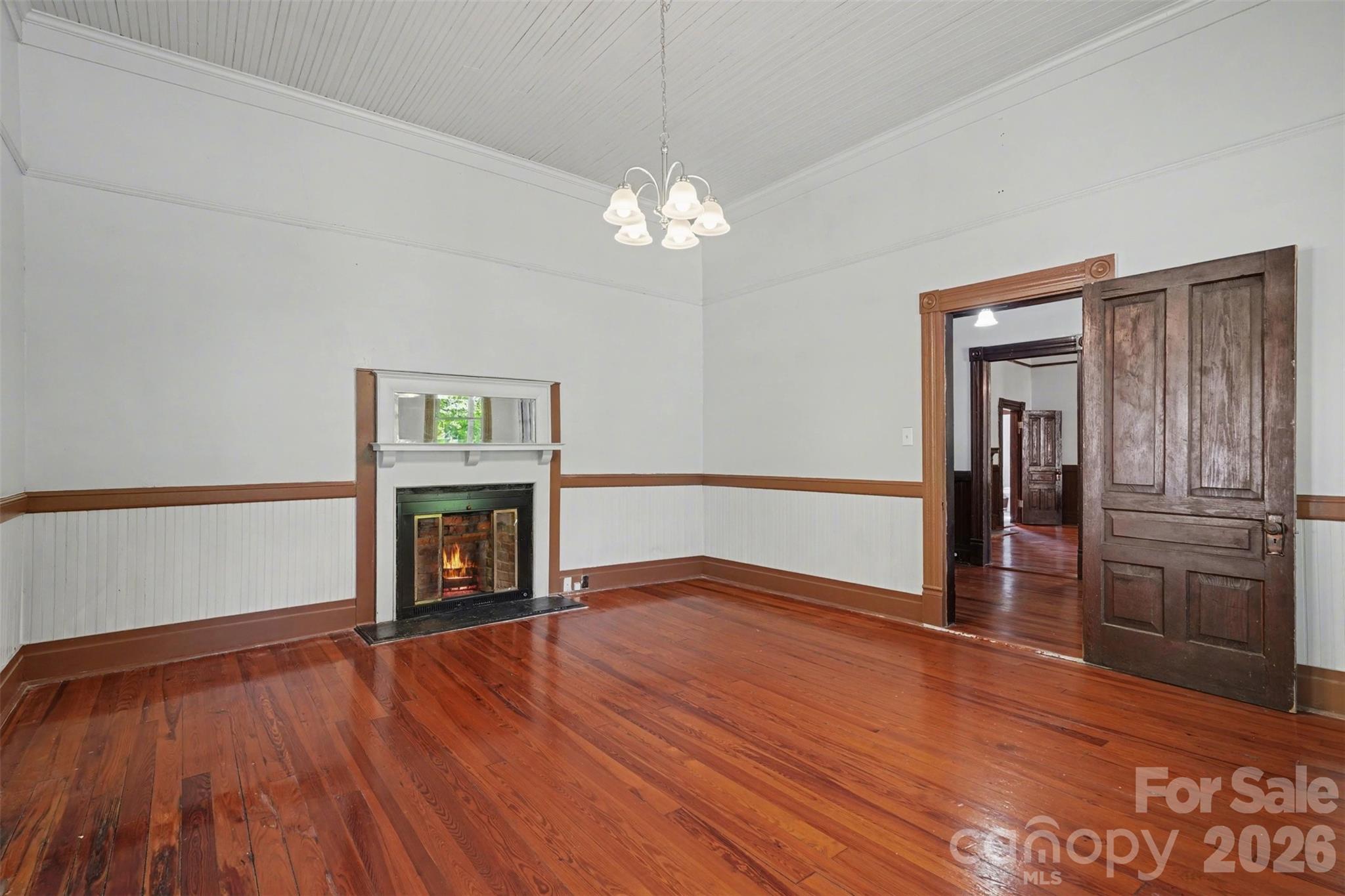 215 Theodore R Carr Avenue Morven, NC 28119 - Photo 16 of 28 a view of empty room with wooden floor fireplace and windows
