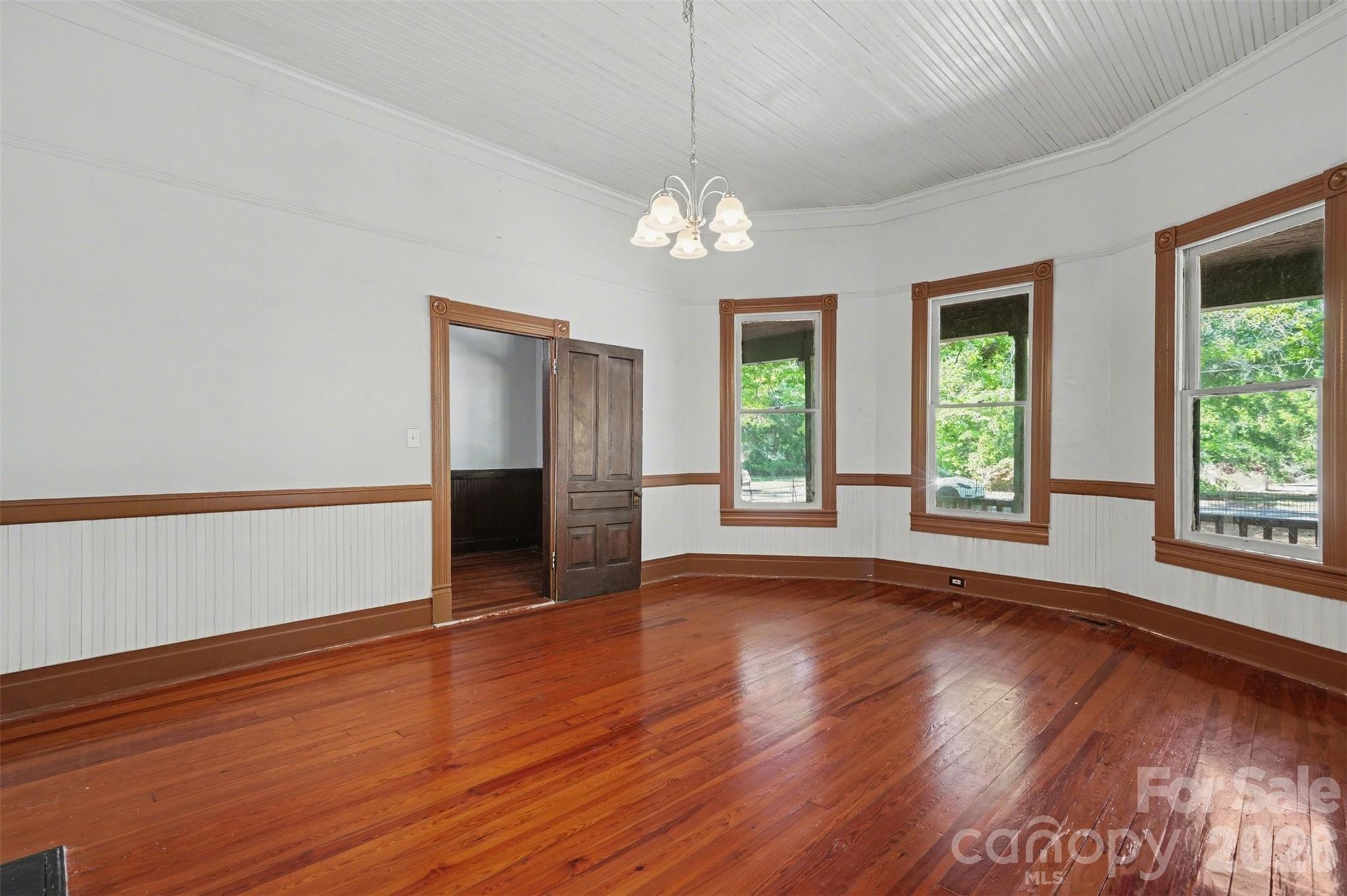 215 Theodore R Carr Avenue Morven, NC 28119 - Photo 17 of 28 a view of an empty room with wooden floor and a window
