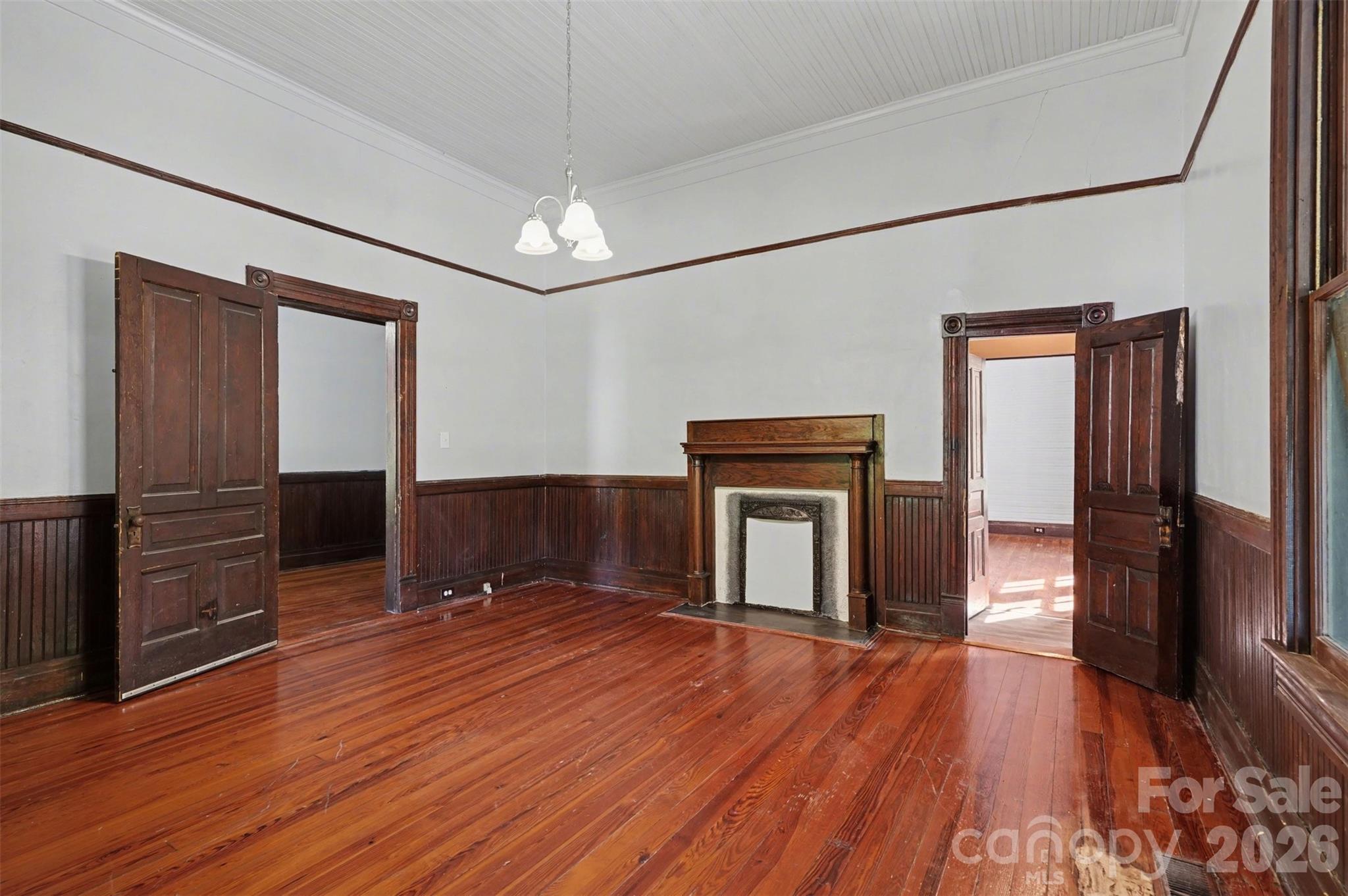 215 Theodore R Carr Avenue Morven, NC 28119 - Photo 23 of 28 an empty room with wooden floor cabinet and windows