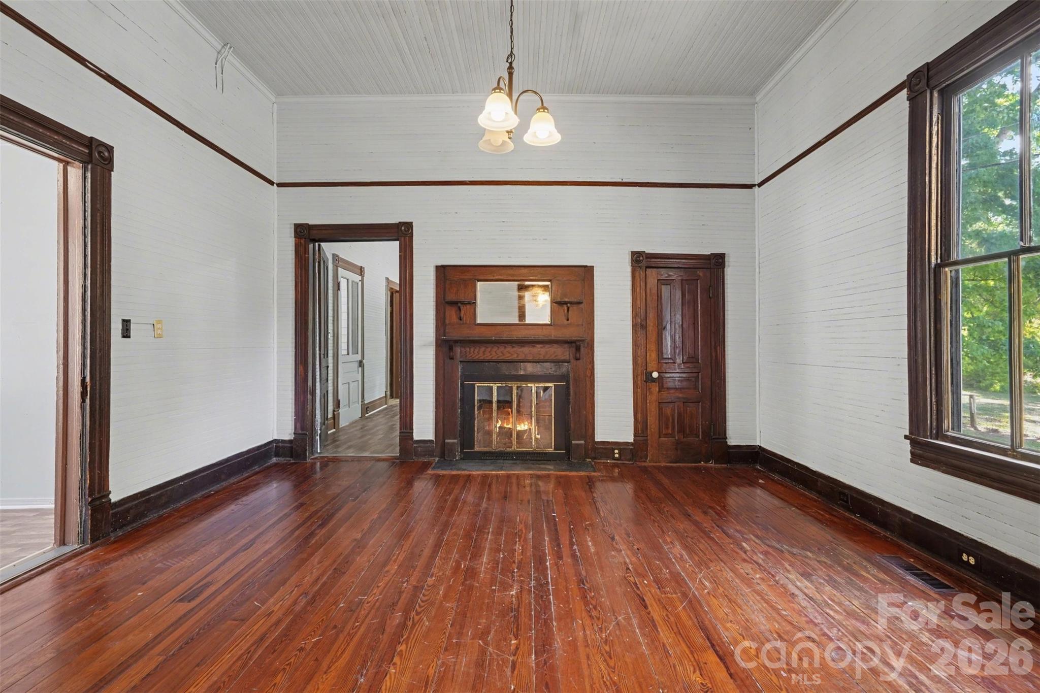 215 Theodore R Carr Avenue Morven, NC 28119 - Photo 6 of 28 wooden floor in an empty room with a window