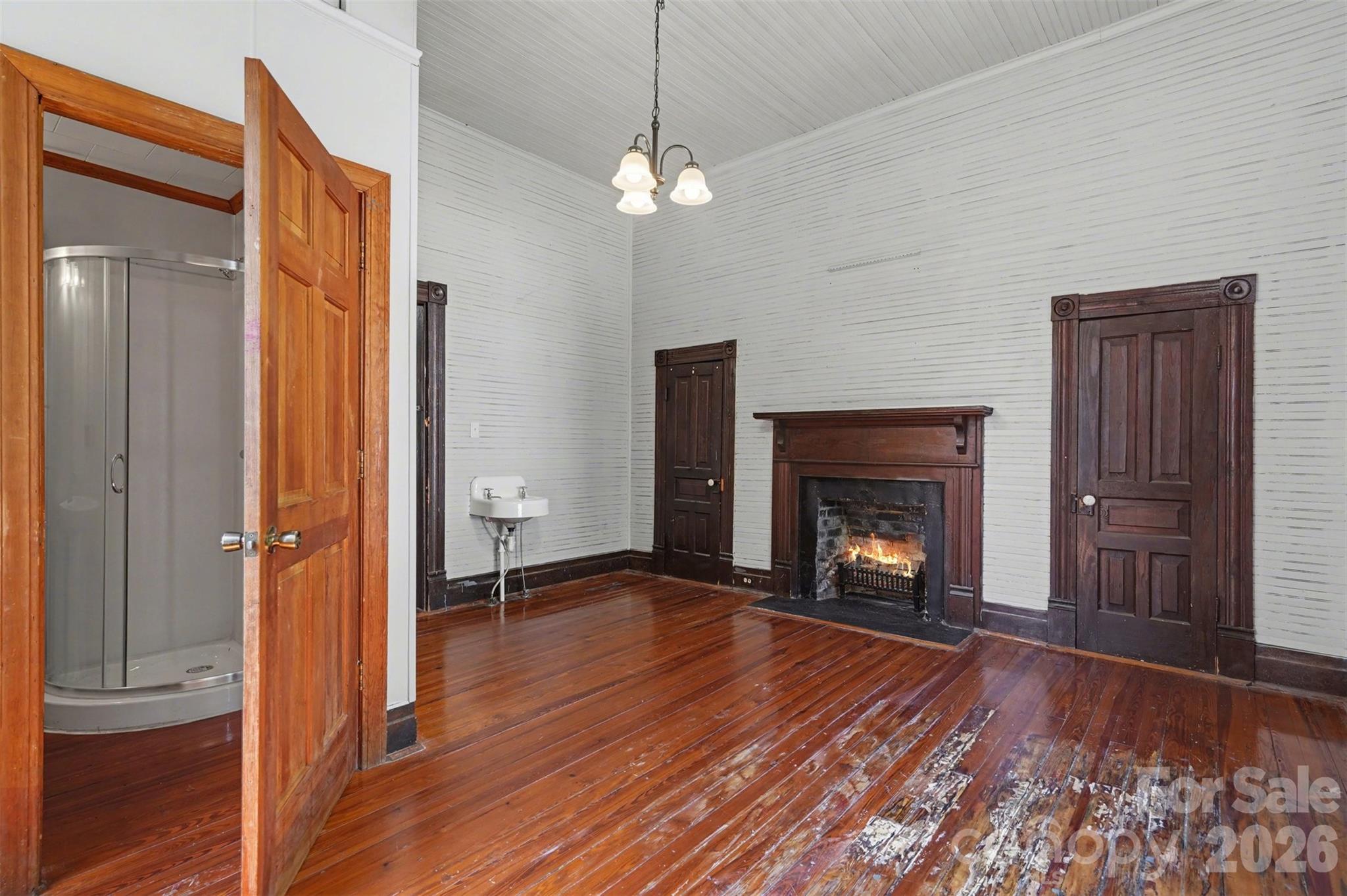 215 Theodore R Carr Avenue Morven, NC 28119 - Photo 7 of 28 a view of an empty room with wooden floor fireplace and a window