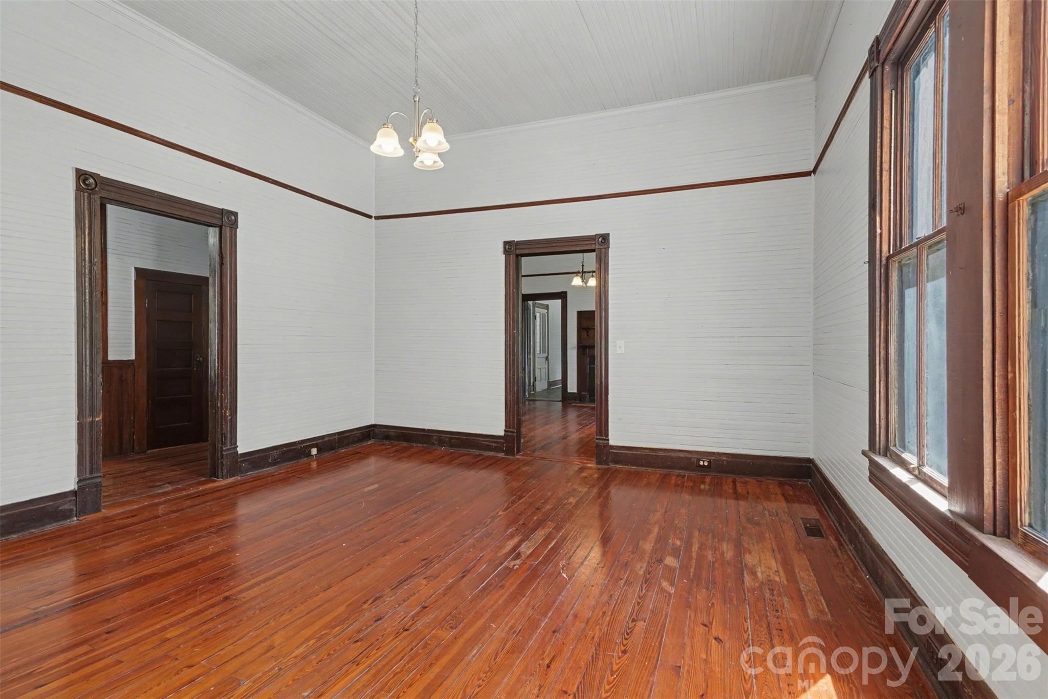 215 Theodore R Carr Avenue Morven, NC 28119 - Photo 8 of 28 a view of an empty room with wooden floor and a window