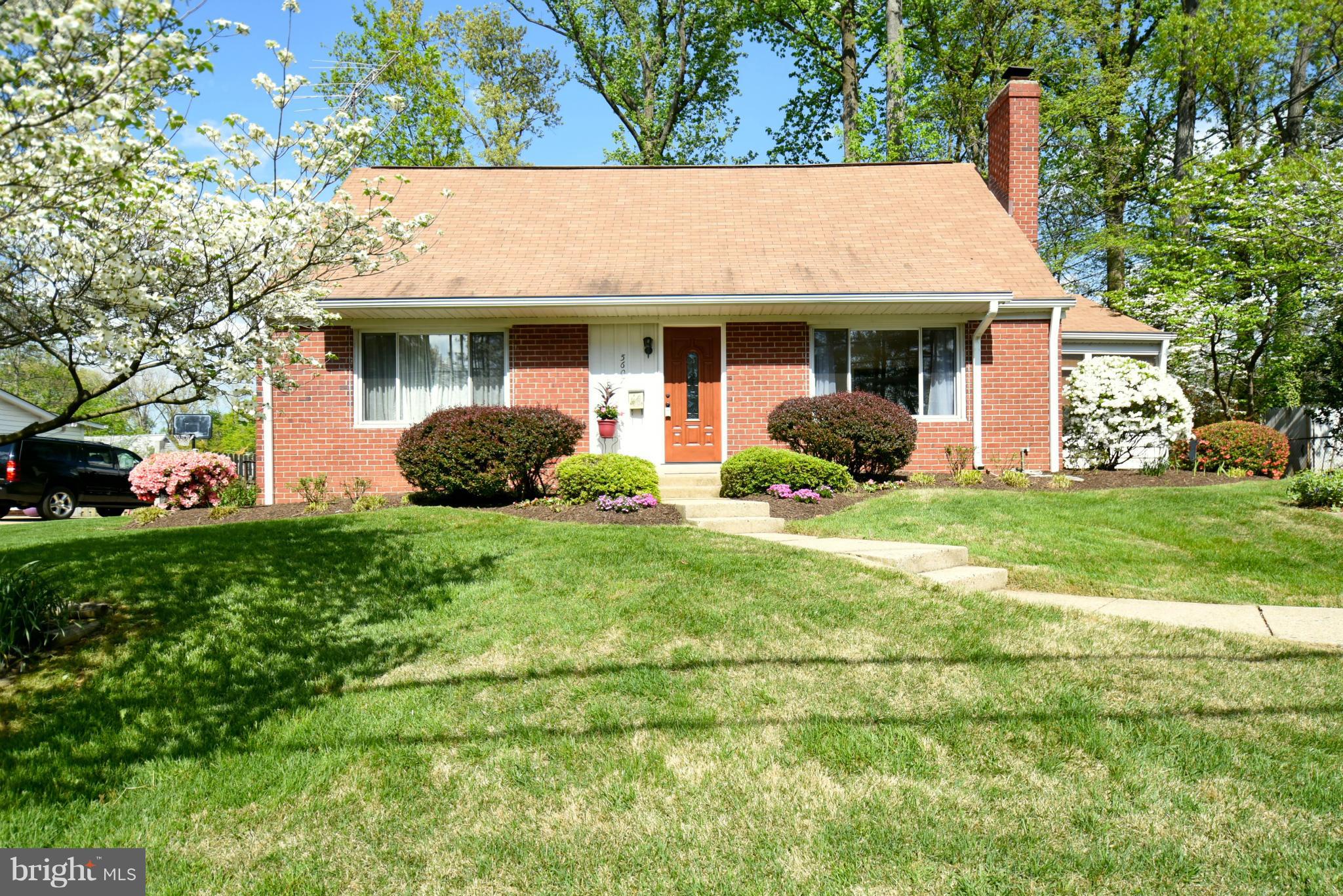 5607 Rolling Road Springfield, VA 22151 - Photo 2 of 30 a front view of a house with a garden and plants
