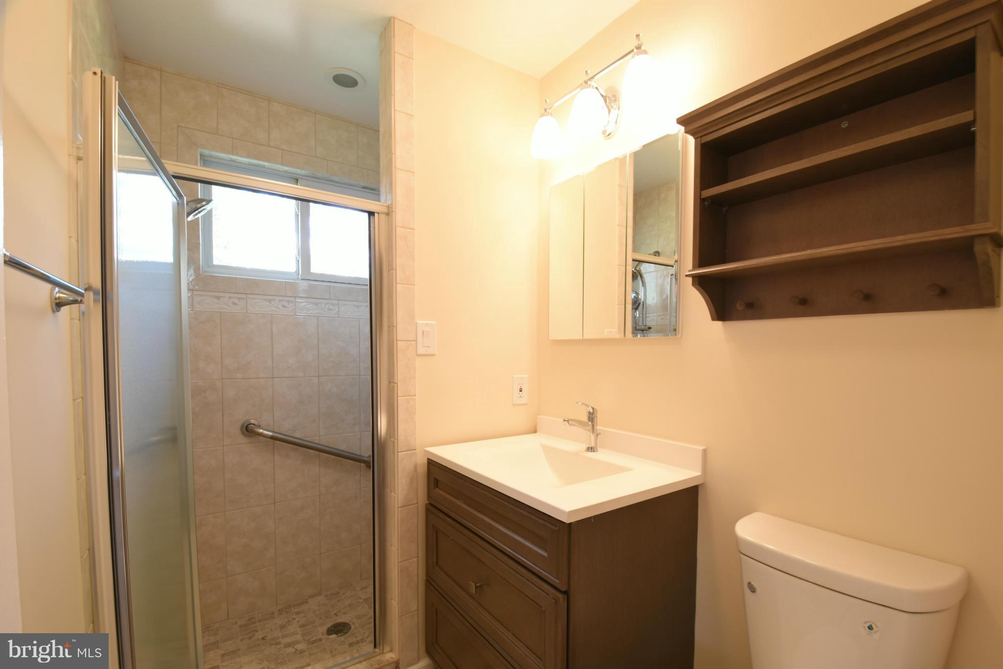 5607 Rolling Road Springfield, VA 22151 - Photo 14 of 30 a bathroom with a sink a toilet and shower