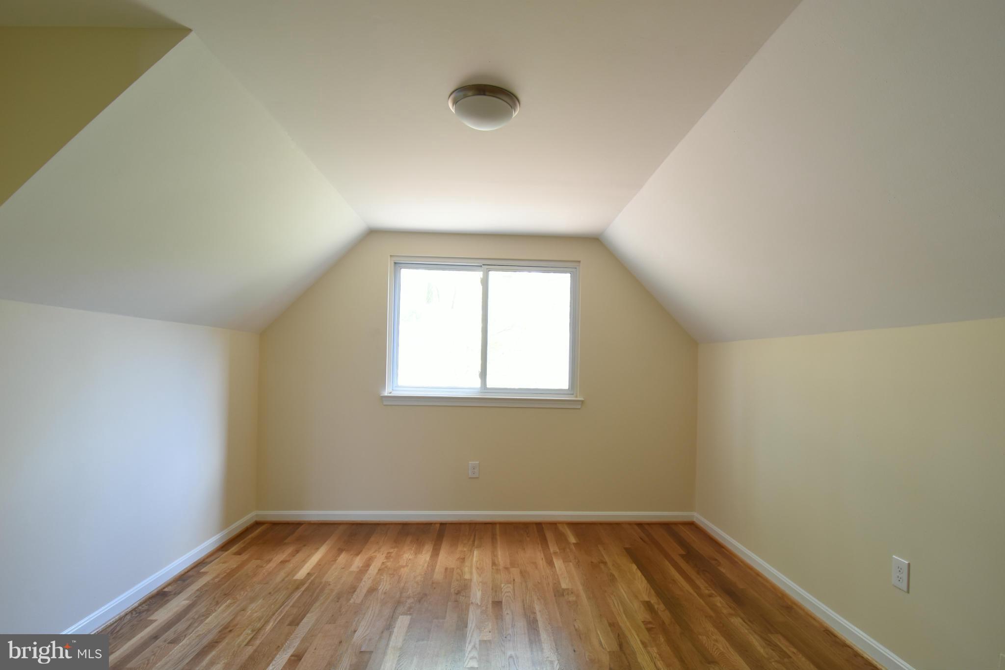 5607 Rolling Road Springfield, VA 22151 - Photo 15 of 30 an empty room with wooden floor and windows