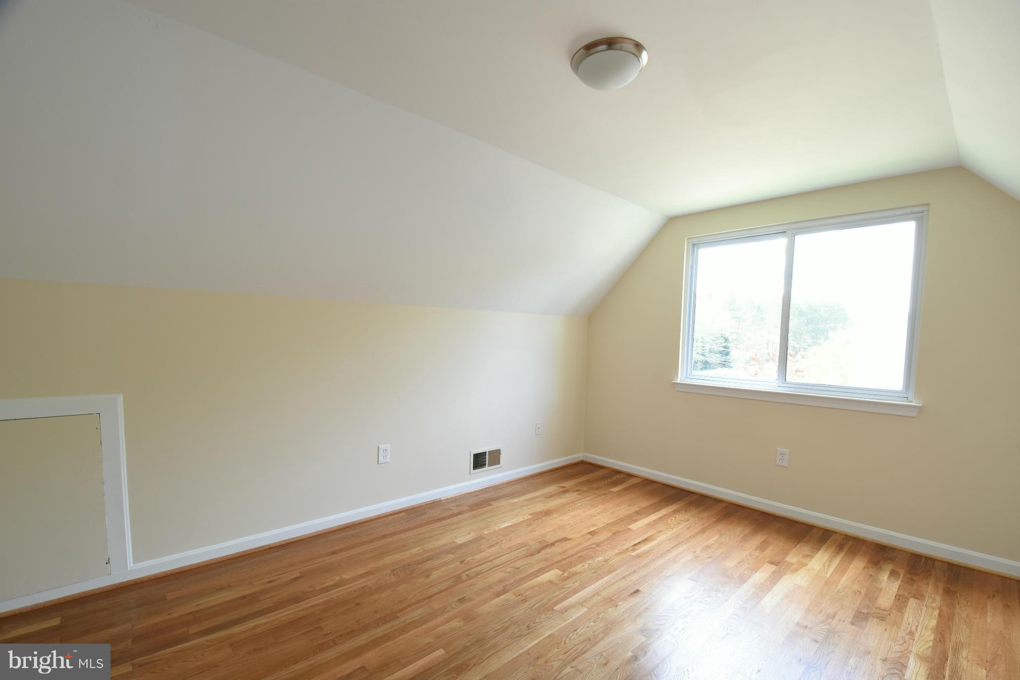 5607 Rolling Road Springfield, VA 22151 - Photo 19 of 30 an empty room with wooden floor and windows