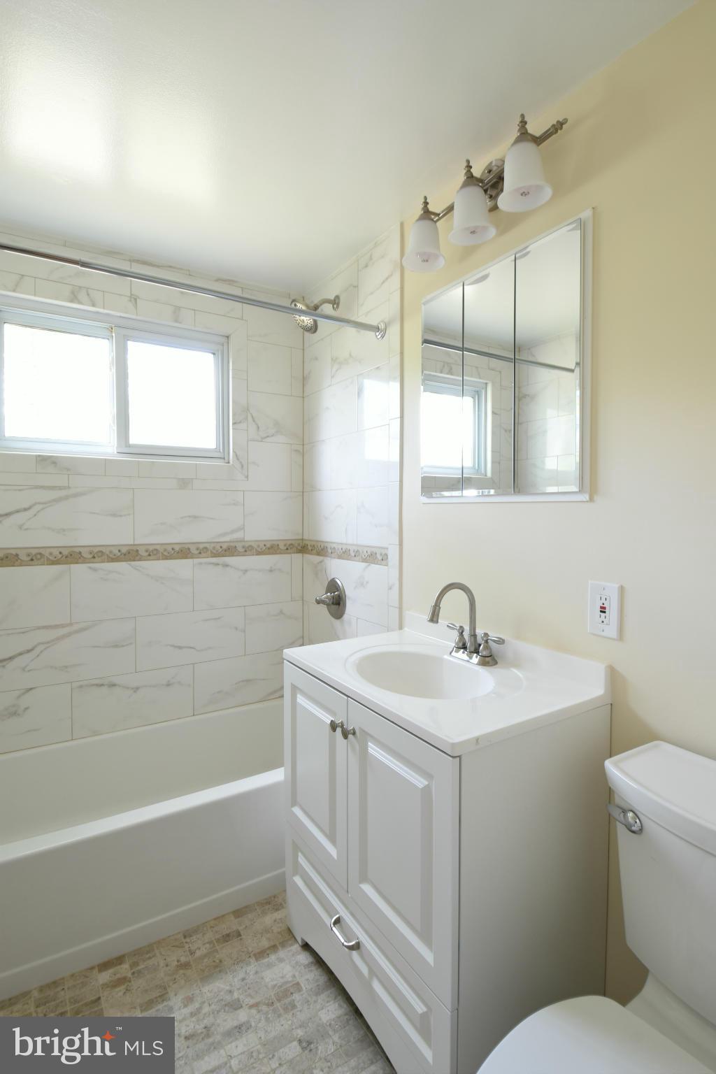 5607 Rolling Road Springfield, VA 22151 - Photo 20 of 30 a bathroom with a sink a toilet and bathtub