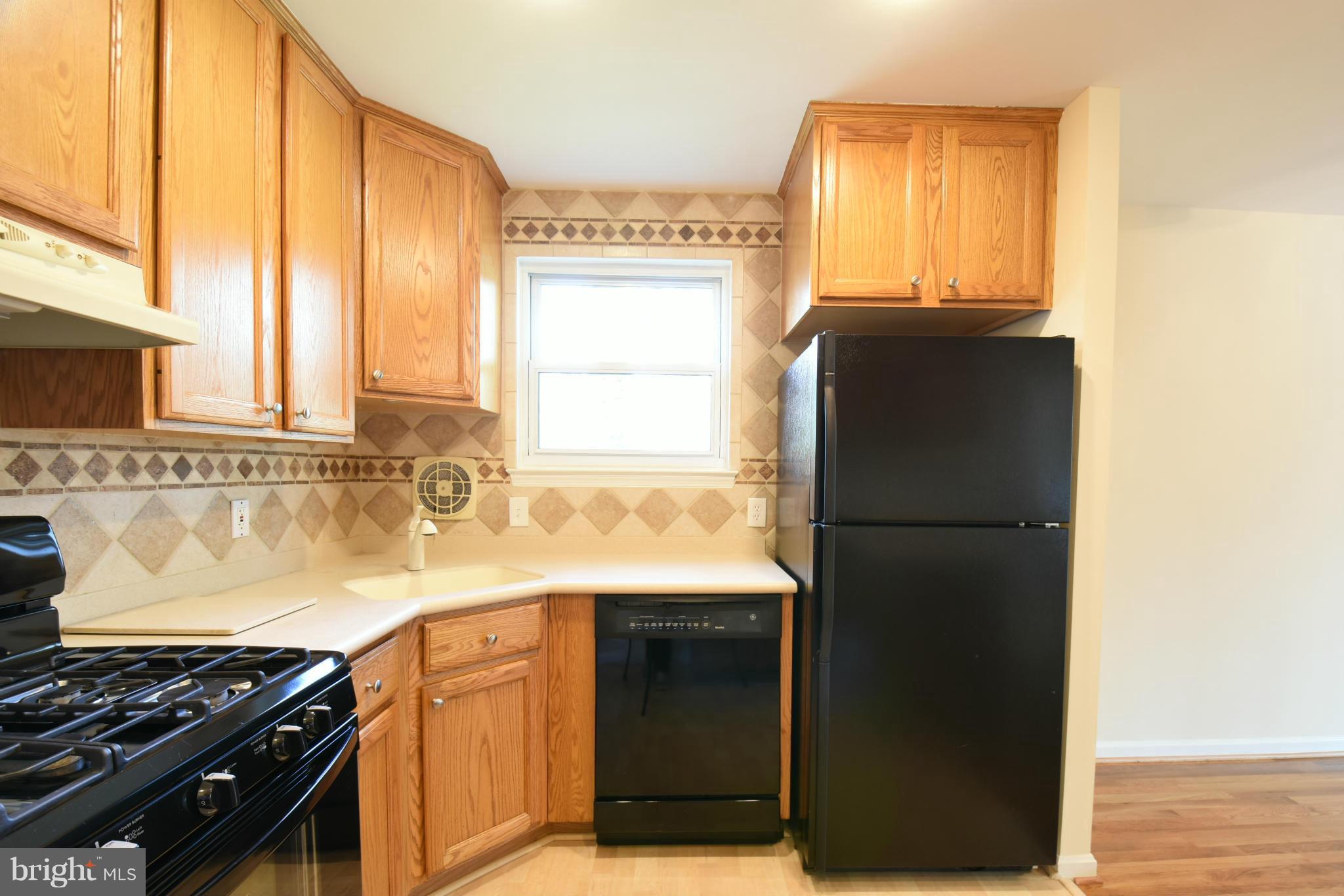 5607 Rolling Road Springfield, VA 22151 - Photo 3 of 30 a kitchen with stainless steel appliances granite countertop a refrigerator and a sink