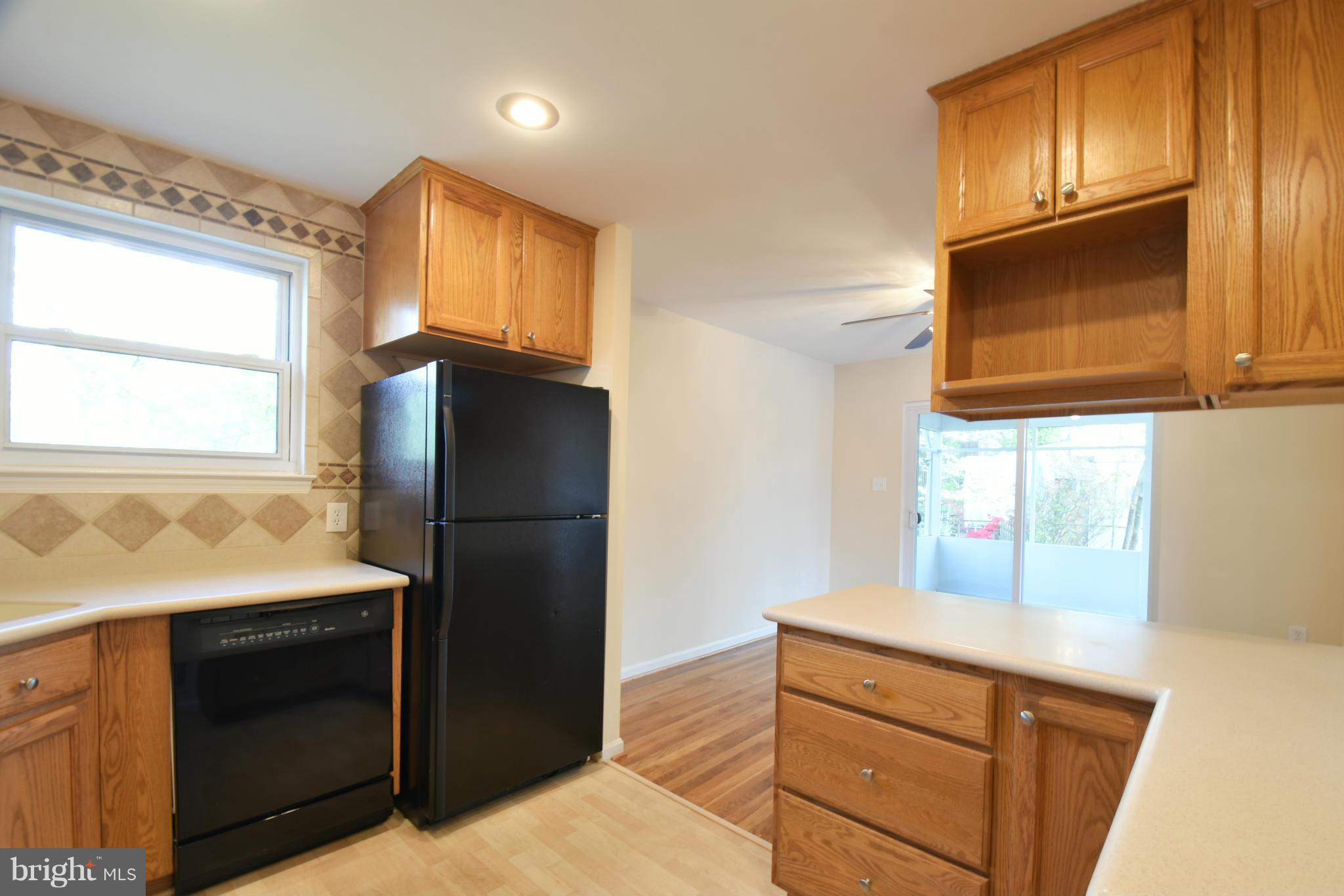 5607 Rolling Road Springfield, VA 22151 - Photo 4 of 30 a kitchen with a refrigerator stove and microwave