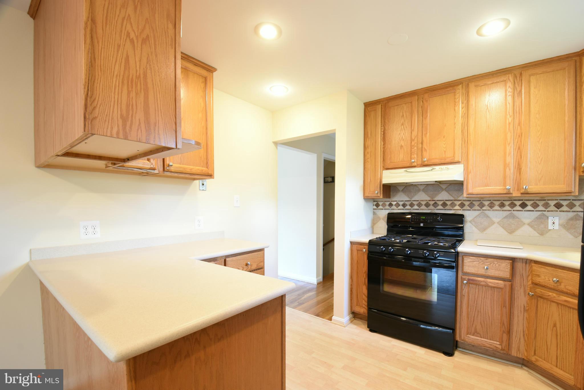 5607 Rolling Road Springfield, VA 22151 - Photo 5 of 30 a kitchen with stainless steel appliances granite countertop a stove a sink and a refrigerator