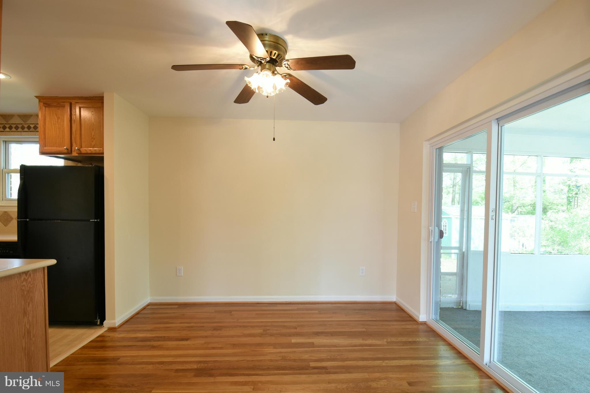 5607 Rolling Road Springfield, VA 22151 - Photo 7 of 30 a view of an empty room with wooden floor and a window