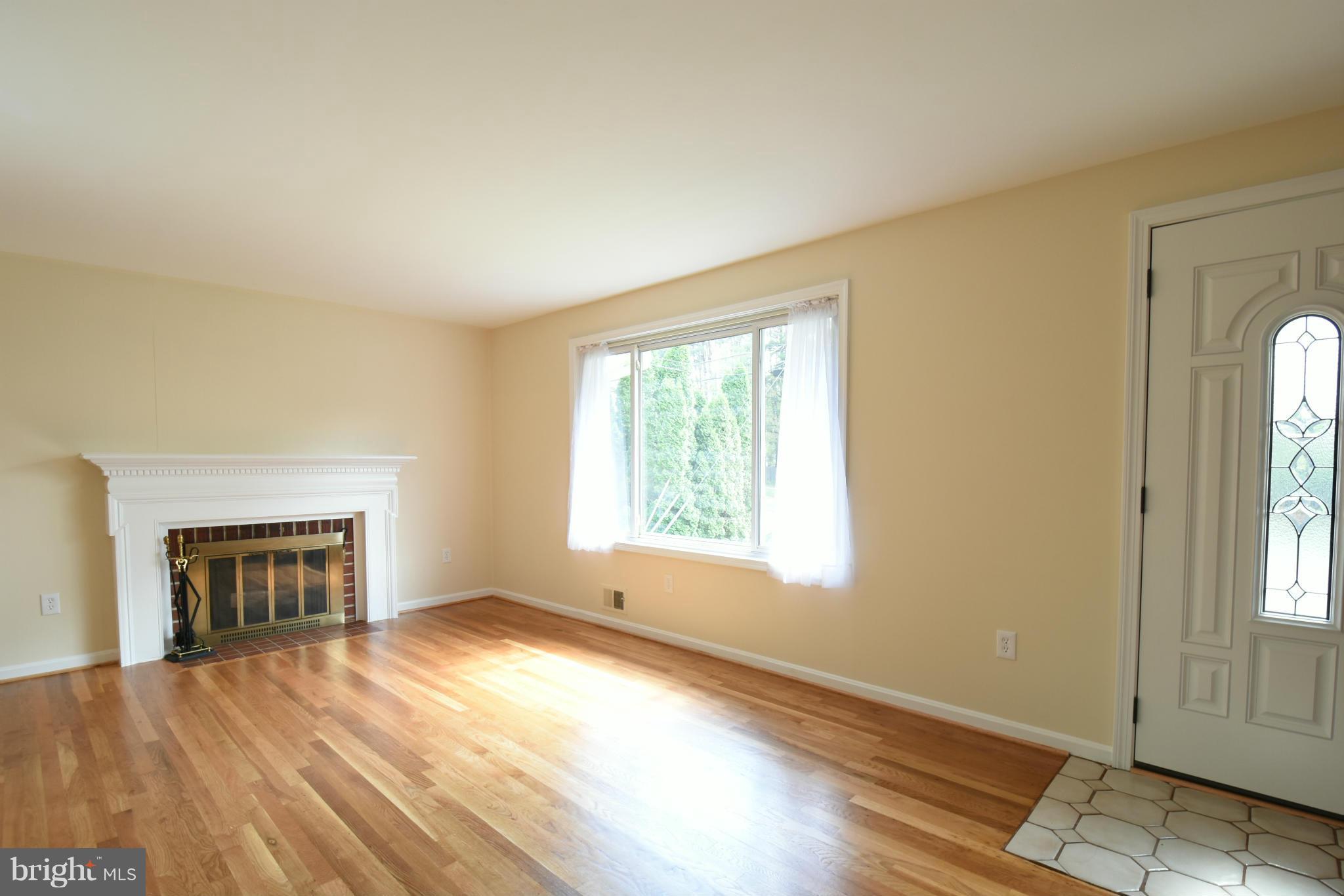 5607 Rolling Road Springfield, VA 22151 - Photo 9 of 30 an empty room with windows and a fireplace