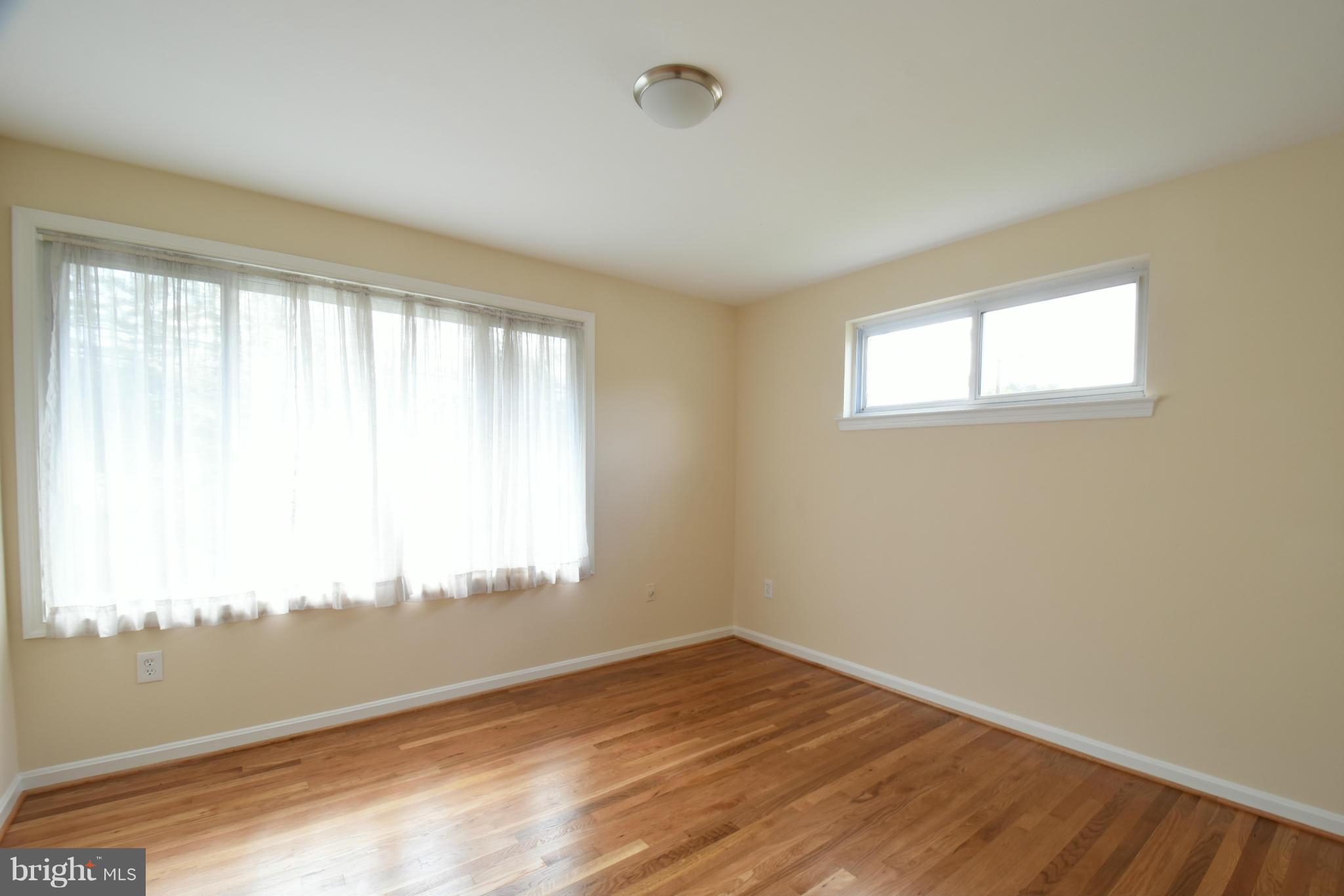 5607 Rolling Road Springfield, VA 22151 - Photo 10 of 30 a view of empty room with wooden floor and fan