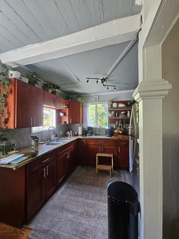 a view of a backyard with table and chairs under an umbrella