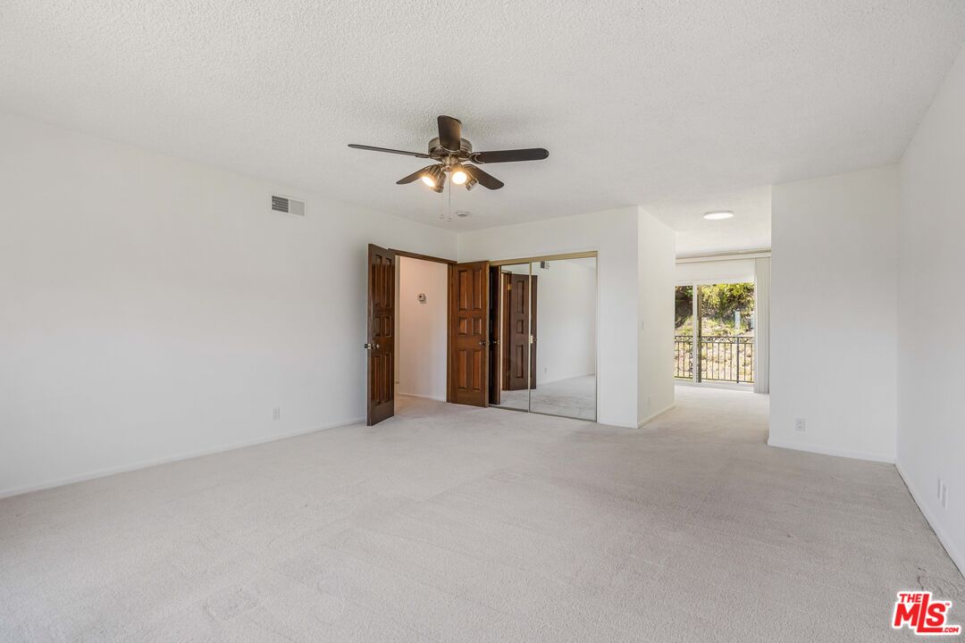 1181 Somera Road Los Angeles, CA 90077 - Photo 20 of 40 a view of a livingroom with a ceiling fan and window