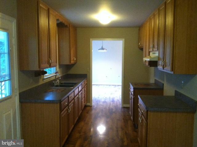 5130 Partlow Road Partlow, VA 22534 - Photo 2 of 10 a kitchen with granite countertop a sink a stove and cabinets