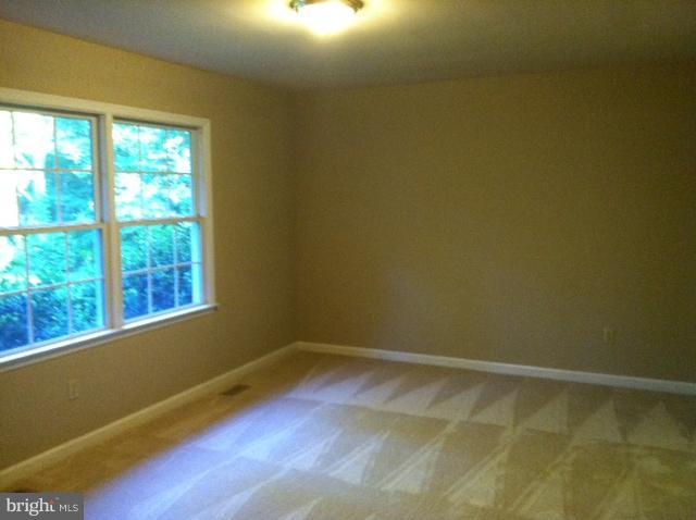 5130 Partlow Road Partlow, VA 22534 - Photo 4 of 10 a view of an empty room with wooden floor and a window