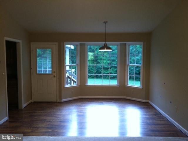 5130 Partlow Road Partlow, VA 22534 - Photo 10 of 10 a view of an empty room with wooden floor fridge and a window
