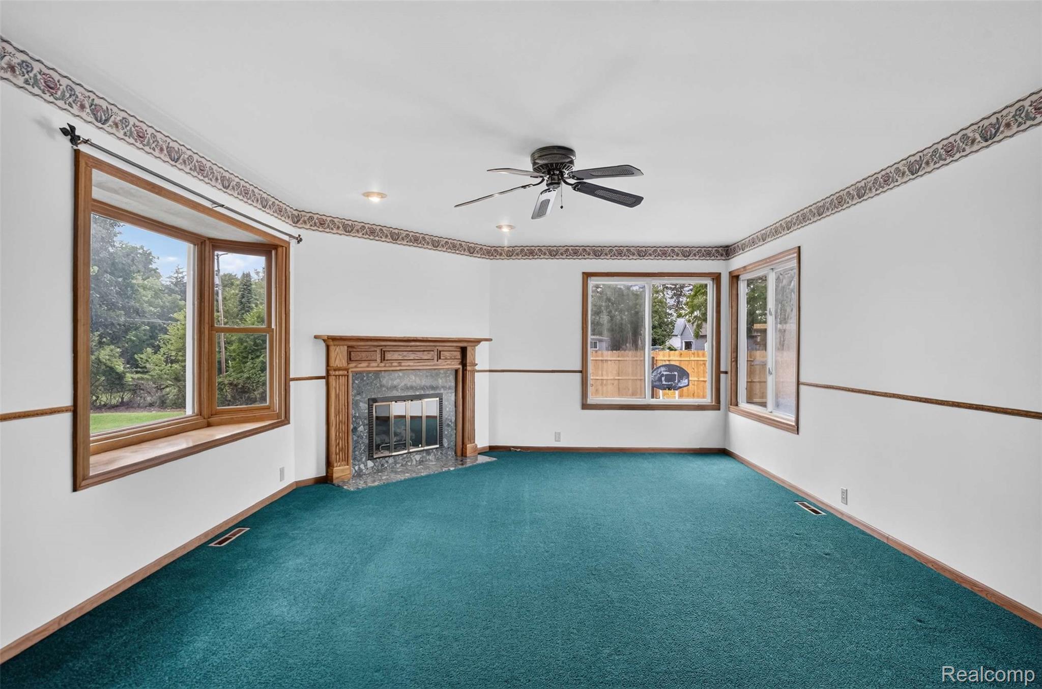 1437 East Cook Road Grand Blanc, MI 48439 - Photo 37 of 69 Spacious room featuring a wood-mantled fireplace with a dark stone surround, a ceiling fan, and recessed lighting