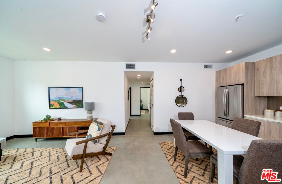 11445 Riverside Drive, Unit 101 North Hollywood, CA 91602 - Photo 6 of 21 a living room with furniture and wooden floor