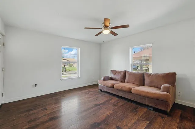 a living room with furniture and a view of kitchen