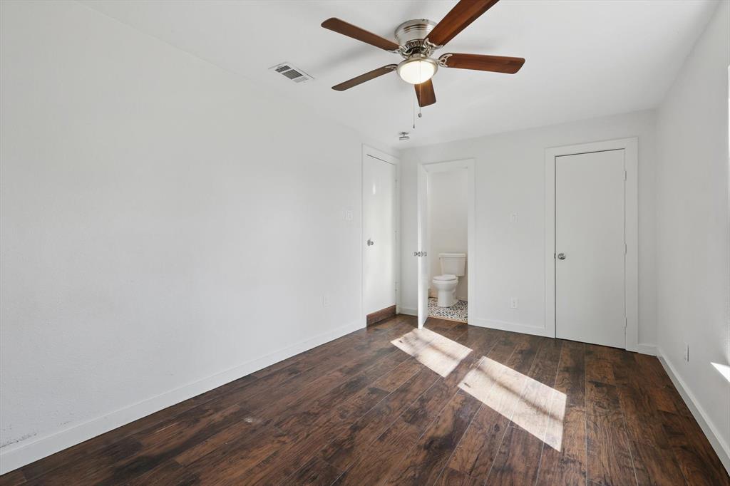 1805 Daniel Street Fort Worth, TX 76104 - Photo 18 of 38 an empty room with wooden floor and a ceiling fan