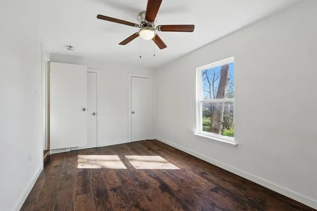 a bathroom with a granite countertop toilet sink and mirror