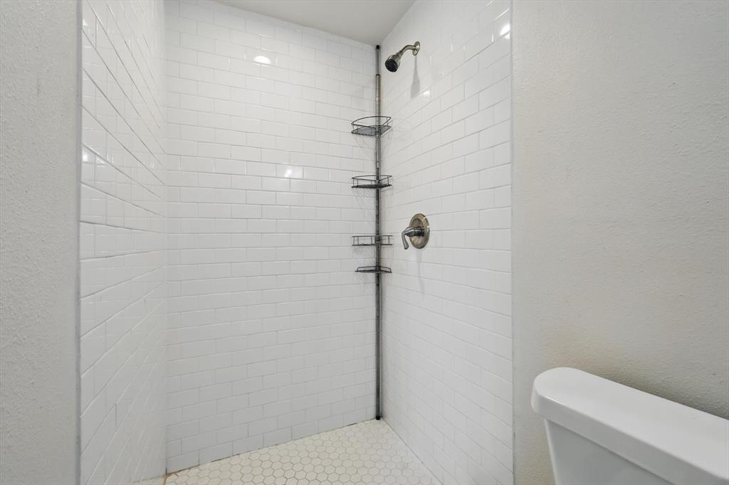 1805 Daniel Street Fort Worth, TX 76104 - Photo 22 of 38 a bathroom with a shower and toilet