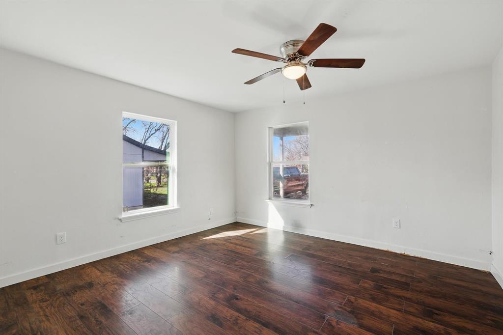 1805 Daniel Street Fort Worth, TX 76104 - Photo 24 of 38 a view of an empty room with wooden floor and a window