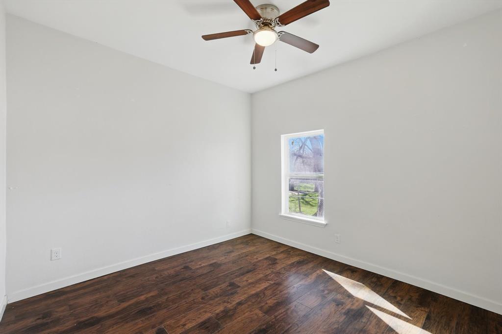 1805 Daniel Street Fort Worth, TX 76104 - Photo 29 of 38 an empty room with a window and ceiling fan