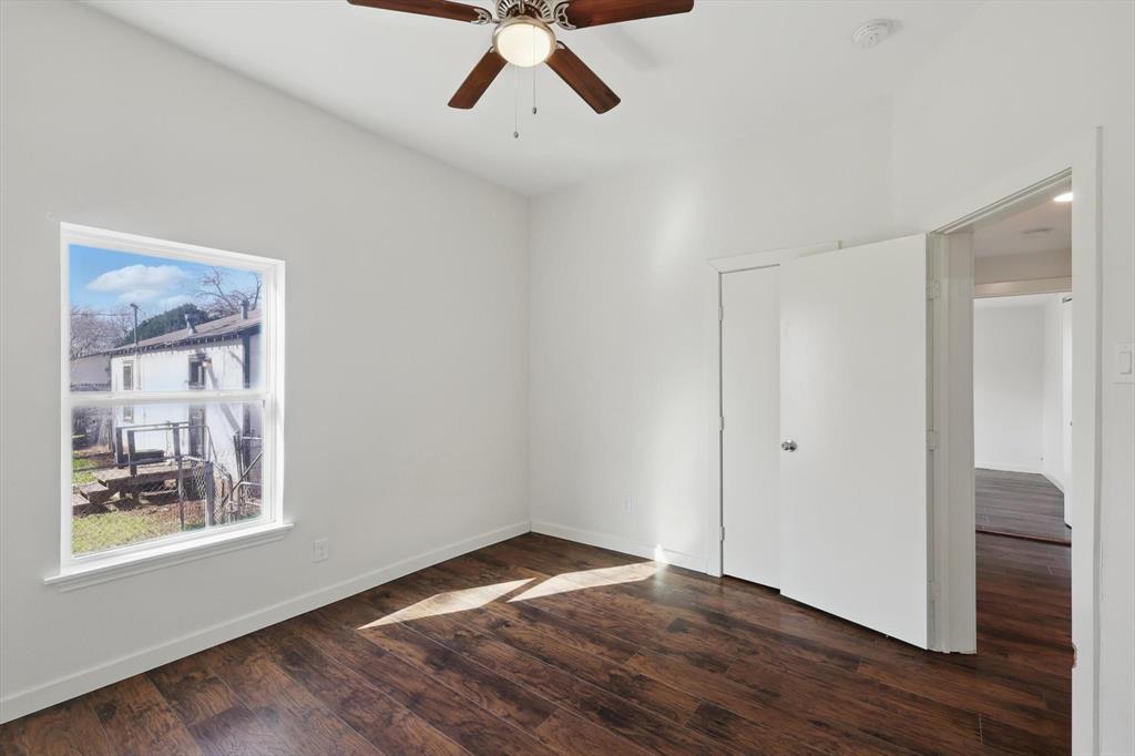 1805 Daniel Street Fort Worth, TX 76104 - Photo 30 of 38 a view of an empty room with wooden floor and a window